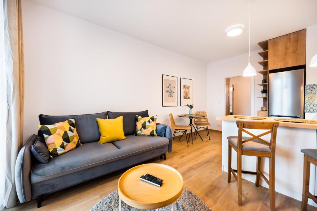 a living room with a couch and a table at Mokotów Passion Apartment in Warsaw