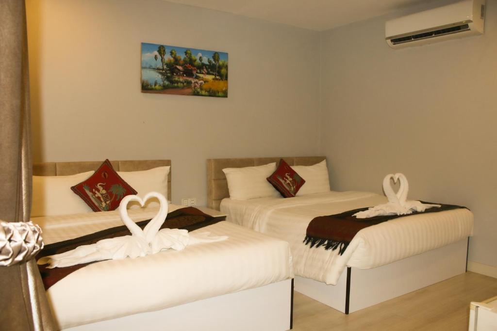 Postel nebo postele na pokoji v ubytování Ostro Hotel