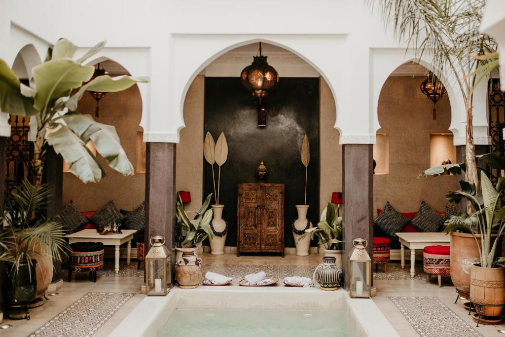 a room with potted plants and a bath tub at Riad Alnadine in Marrakesh