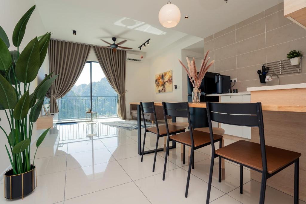 a kitchen and dining room with a table and chairs at 2R2B Lost World of Tambun Sunway Onsen Nara Suite in Ipoh