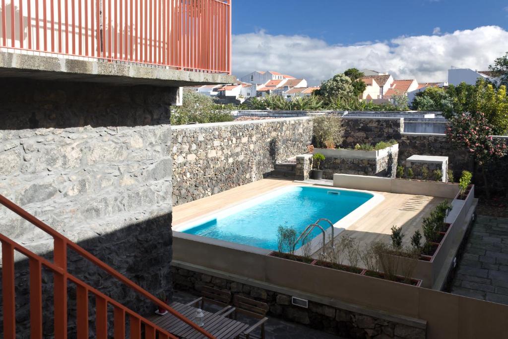 a swimming pool on the side of a building at Azorean Urban Lodge in Ponta Delgada