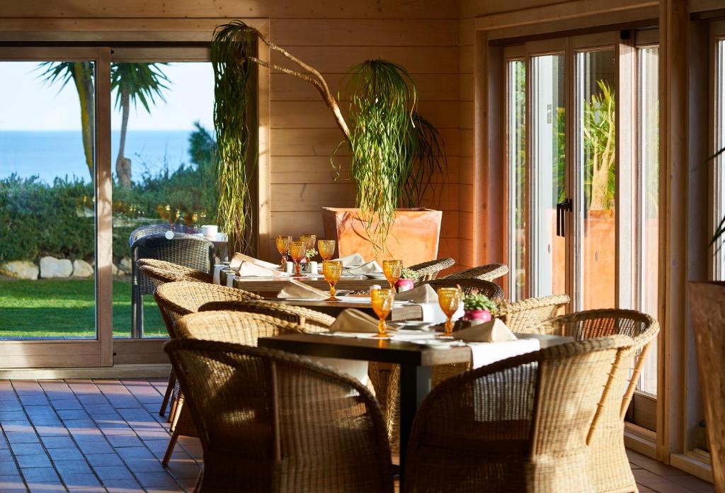 a restaurant with tables and chairs on a patio at PortoBay Falesia in Albufeira