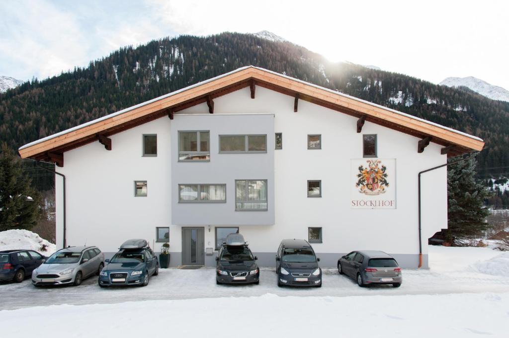 a building with cars parked in front of it at Stöcklhof in Pettneu am Arlberg