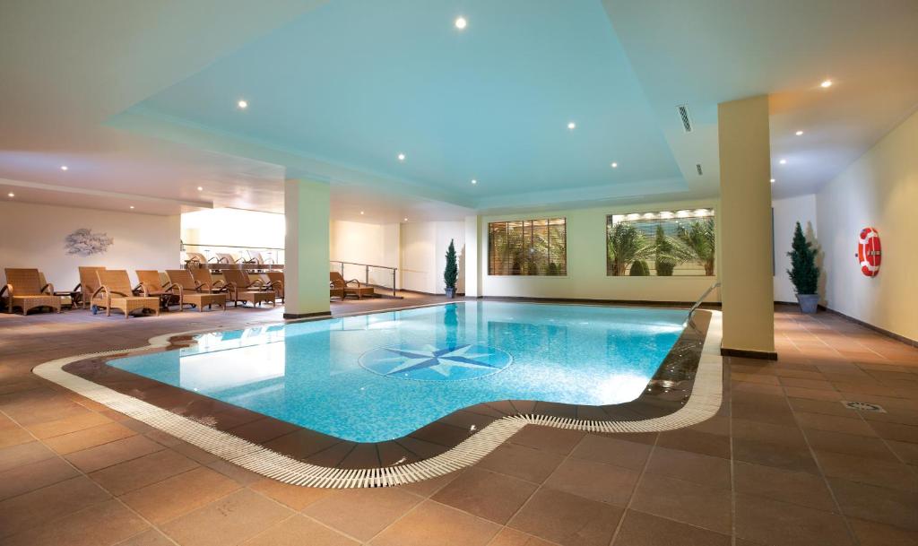 a large swimming pool in a hotel lobby at PortoBay Falesia in Albufeira