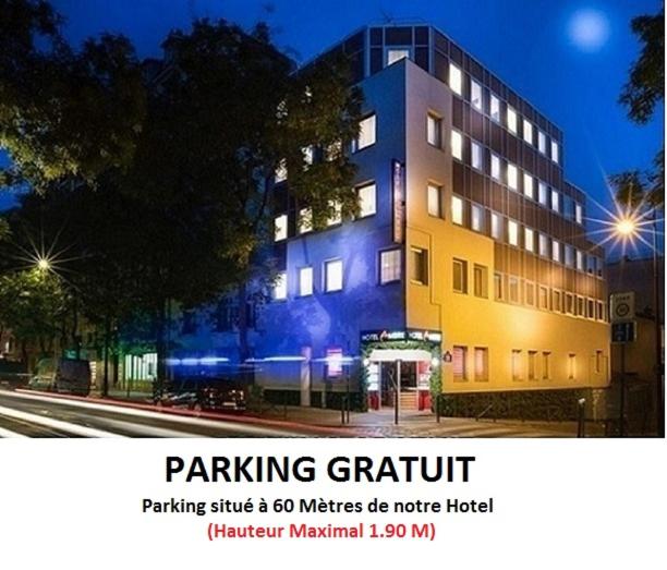 a building with a sign for a parking district with a street at Hôtel Ambre in Paris