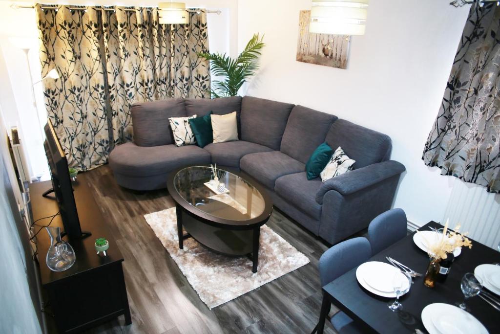a living room with a couch and a table at Lovely 2-Bed Apartment in Harrow in Harrow