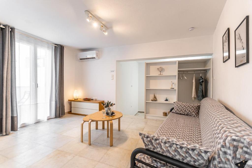 a living room with a couch and a table at Optasia - Naxos Center Cozy House in Naxos Chora