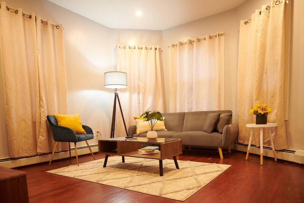 a living room with a couch and a table at Cozy apartment 2nd 10min Walk Downtown and City View in Providence