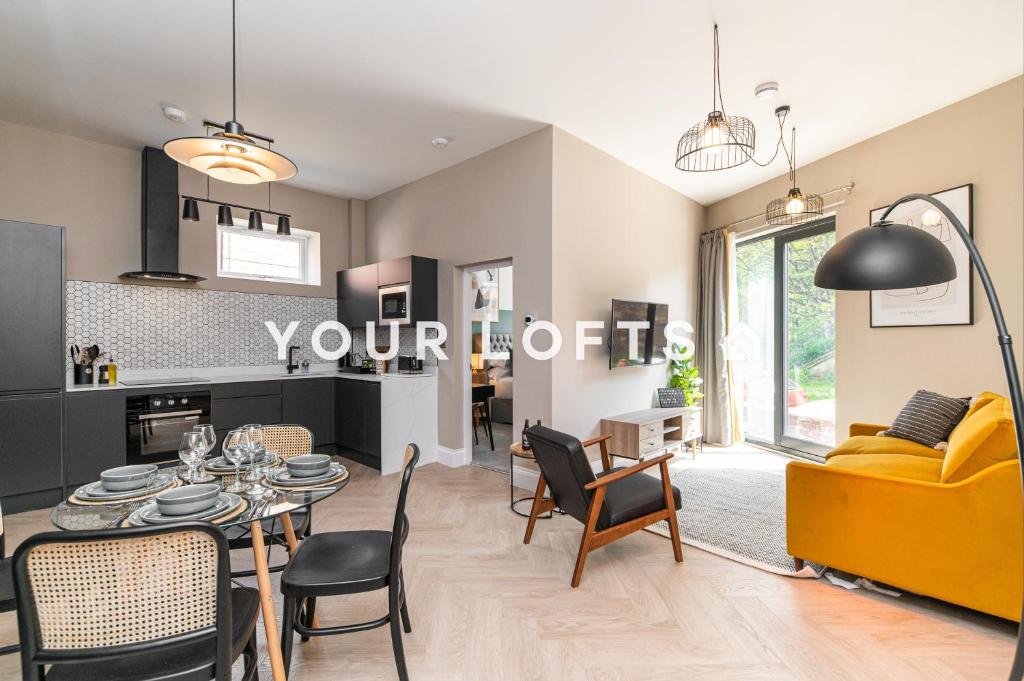 a living room with a table and a yellow couch at Chelmsford Lofts - High-spec luxury apartments in Jesmond