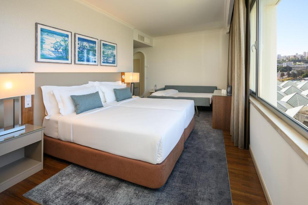 Postel nebo postele na pokoji v ubytování Melia Lisboa Oriente Hotel