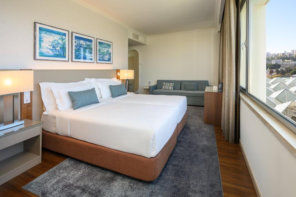 Postel nebo postele na pokoji v ubytování Melia Lisboa Oriente Hotel