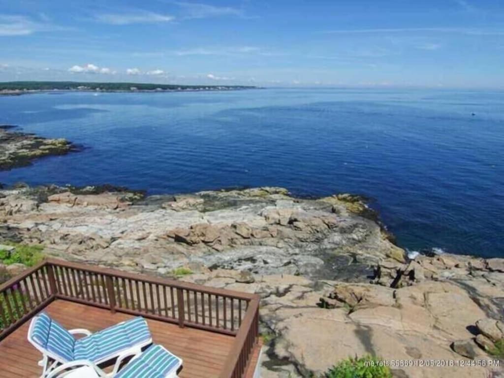 Duas cadeiras sentadas num deque com vista para a água em Nubble Beach House- York Beach Oceanfront w/ Amazing Views em York