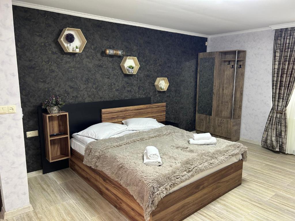 a bedroom with a bed with two towels on it at Oldtown Apartments in Mtskheta
