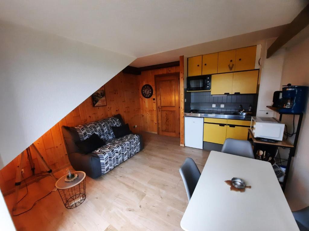 a living room with a couch and a table at Le lorrane in Muhlbach-sur-Munster