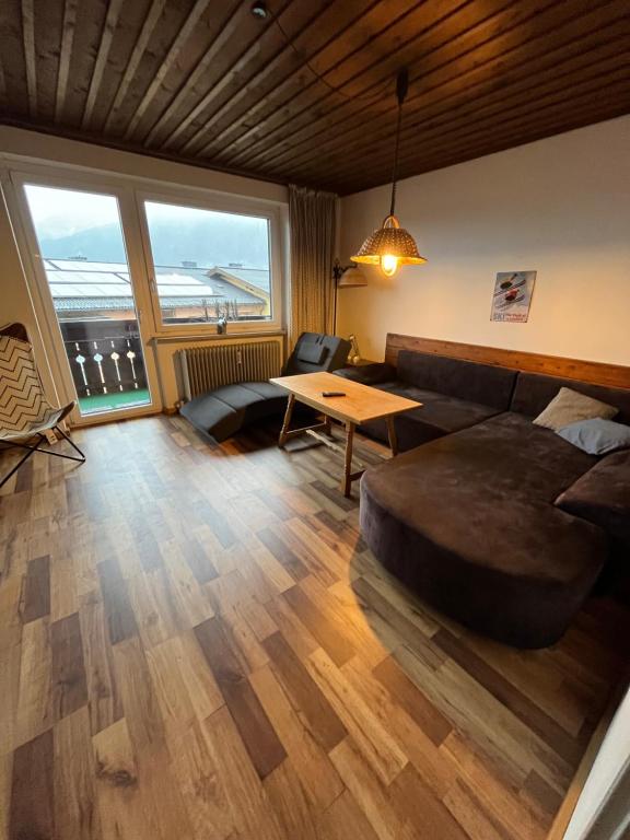 a living room with a large bed and a table at Dachgeschoss-Apartment in Skilift-Nähe in Zell am See