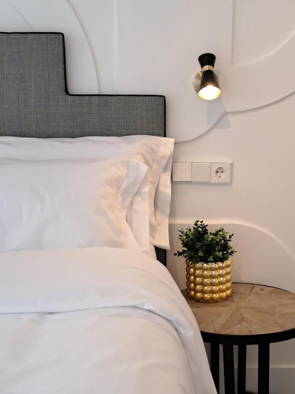 sypialnia z łóżkiem i stołem z rośliną w obiekcie Apartamentos BEJAR - DUCAL w mieście Béjar