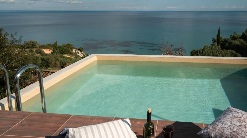 a swimming pool with a view of the ocean at Xigia Escape villas in Khartáta