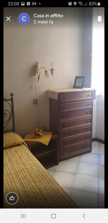 a bedroom with a dresser and a bed and a desk at Casa vacanze Cagliari, in Cagliari