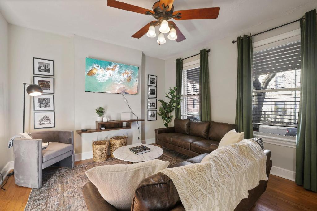 a living room with a couch and a ceiling fan at The Skyline Cottage - 3 BR Garage in Columbus