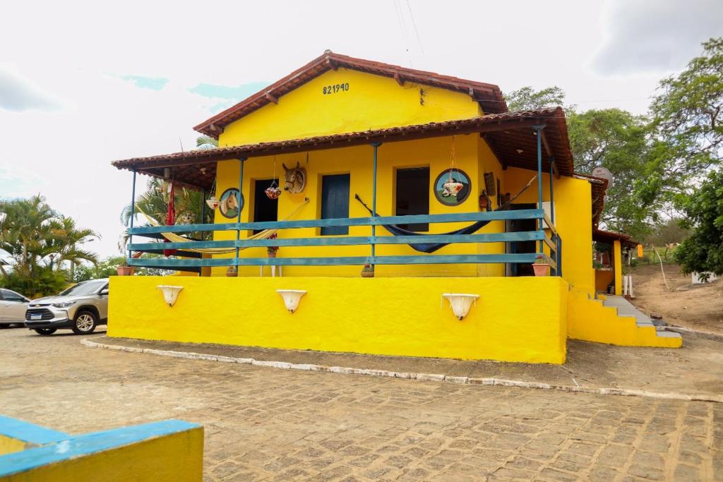 una casa amarilla sentada encima de un estacionamiento en Fazenda Alto Alegre Pousada, en Bonito