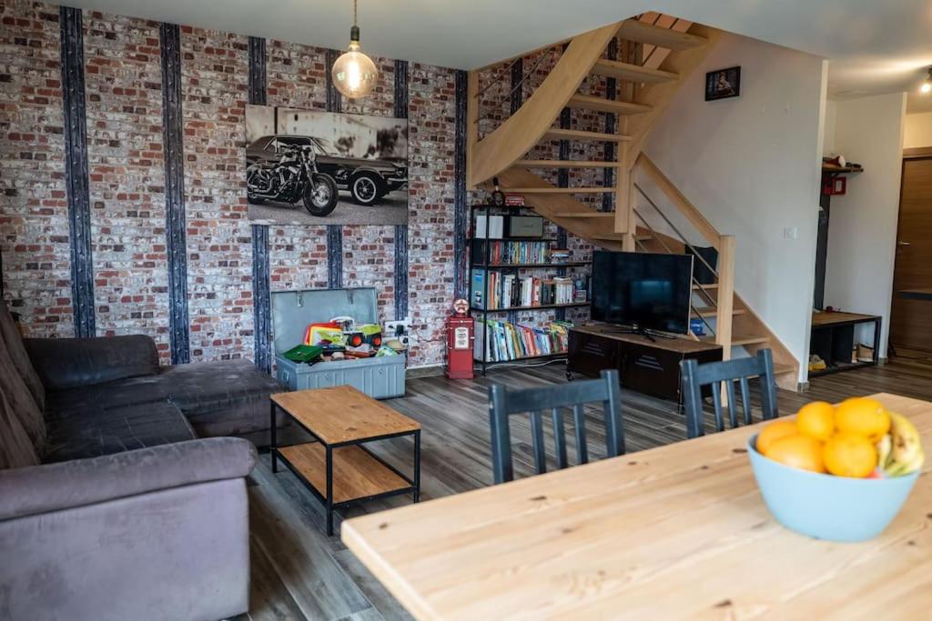 a living room with a couch and a table at logement entier au calme in Étercy