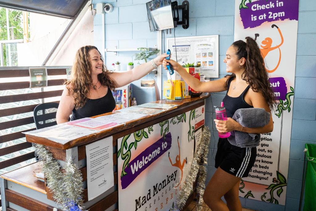 two women standing at a counter in a store at Mad Monkey Waterfront in Cairns