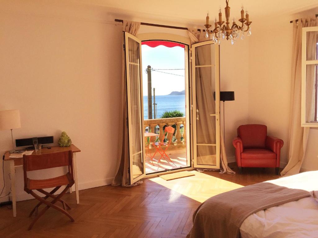 a bedroom with a bed and a view of the ocean at Villa Tricia Cannes in Cannes