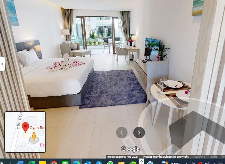 ein Schlafzimmer mit einem Bett und ein Wohnzimmer in der Unterkunft CYAN Resort Kamala Beach Apartments Condominiums in Kamala Beach