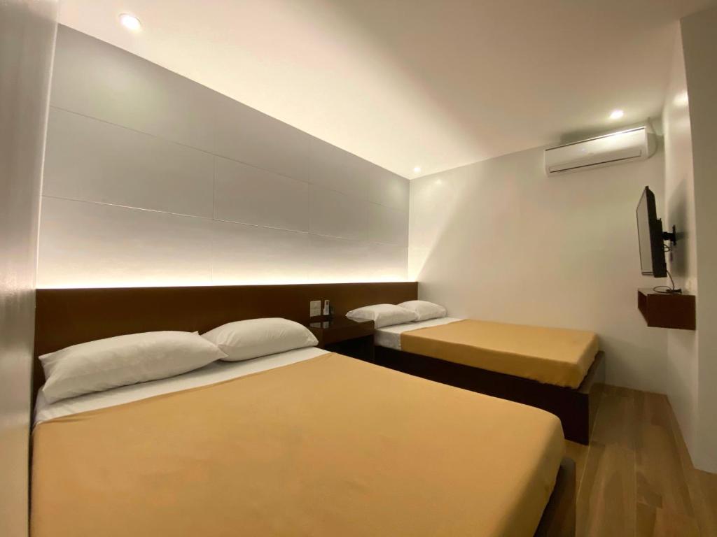 Un pat sau paturi într-o cameră la Espineli's