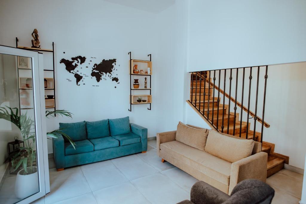 a living room with a couch and a chair at Pura Vida Concordia in Concordia