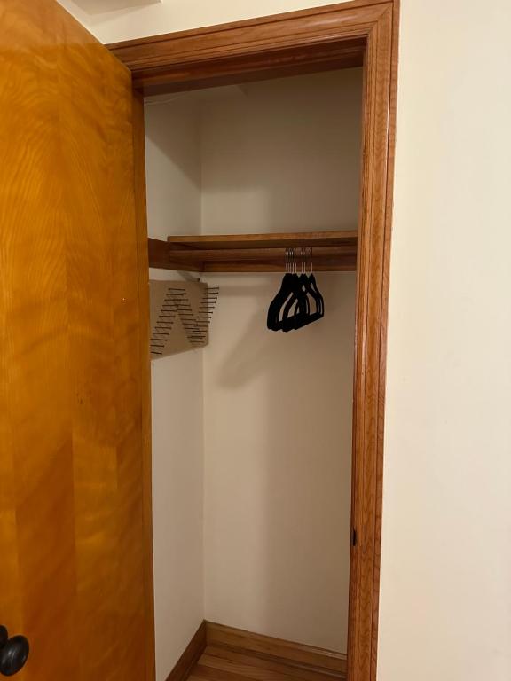a closet with a wooden frame and a hanging rack at M1 Queen Size BedRoom with desk near Rutgers U & hospitals in New Brunswick