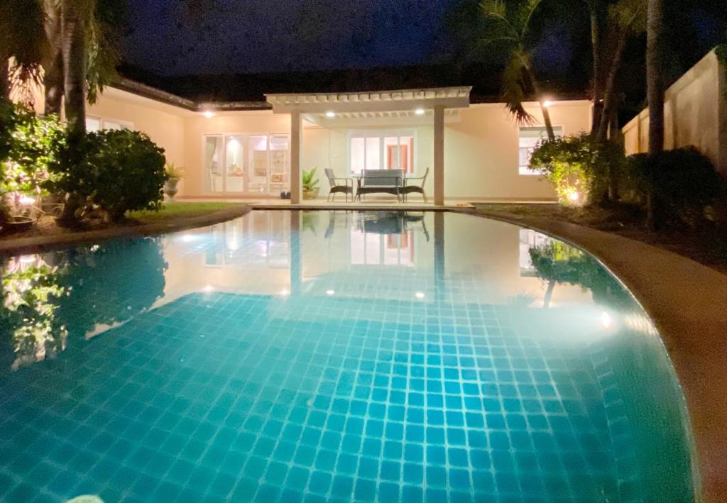 una piscina por la noche en una casa en Sunny3 villa Pattaya, en Ban Huai Yai