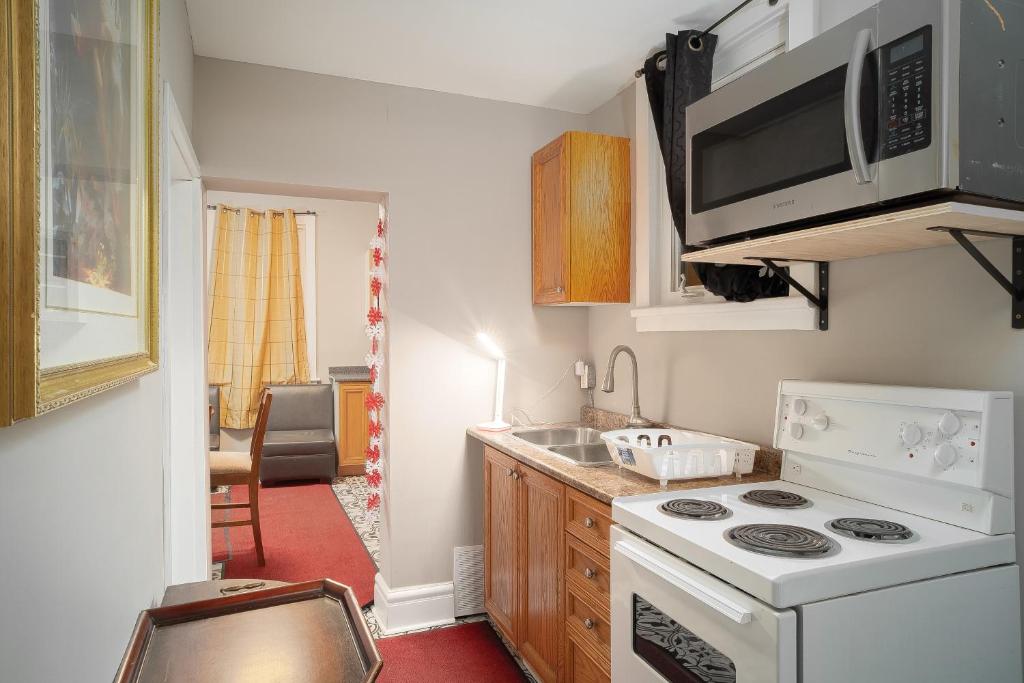 a kitchen with a stove and a microwave at Room #2 downtown ottawa in Ottawa
