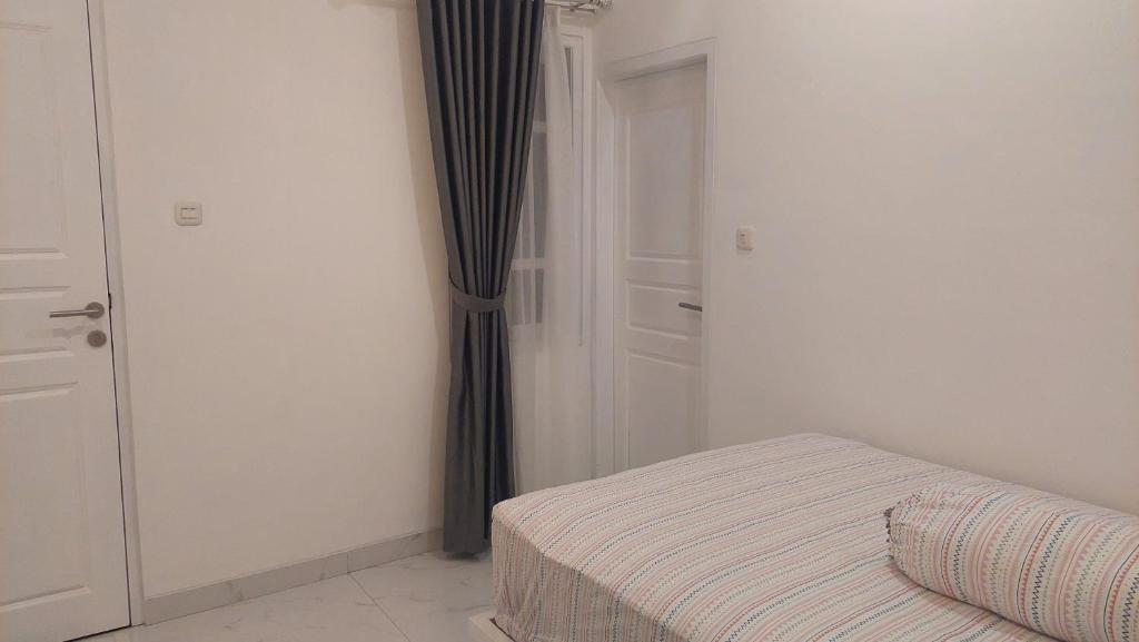 Postel nebo postele na pokoji v ubytování Hotel Wisma Mangurna