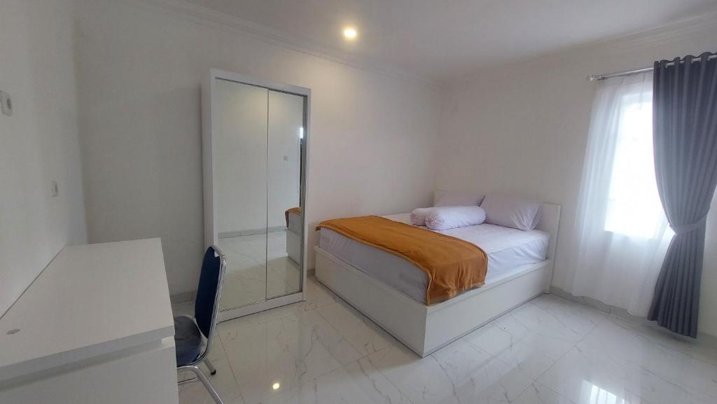 Postel nebo postele na pokoji v ubytování Hotel Wisma Mangurna