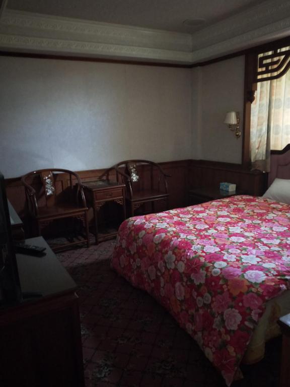 Postel nebo postele na pokoji v ubytování New Daxi B&B
