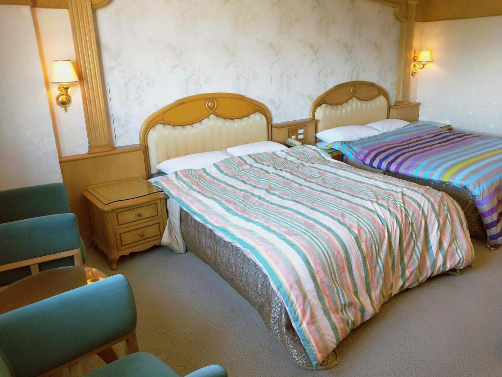 Postel nebo postele na pokoji v ubytování New Daxi B&B