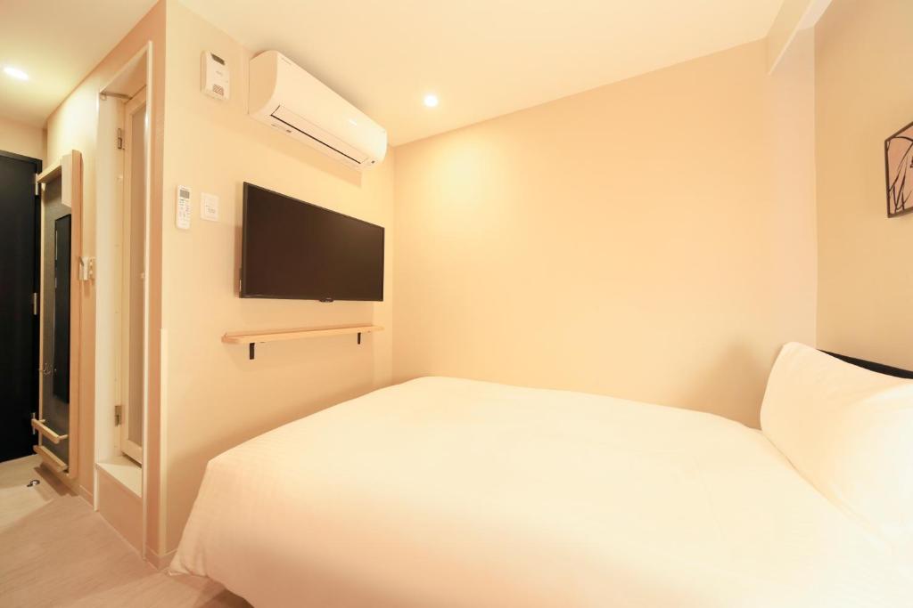 Postel nebo postele na pokoji v ubytování Hotel Nihonbashi Saibo