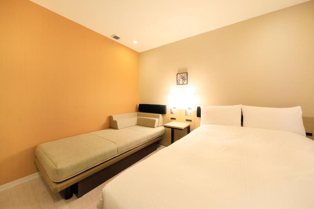 Postel nebo postele na pokoji v ubytování Hotel Nihonbashi Saibo