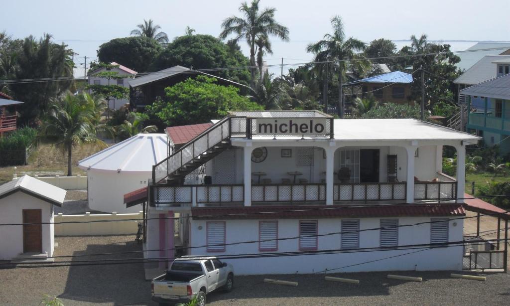 a building with a sign on the top of it at Michelo Suites in Placencia