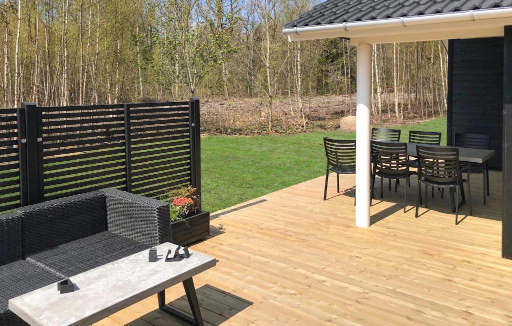 a wooden deck with a gazebo and a table and chairs at 3 Bedroom Awesome Home In Hasle in Hasle