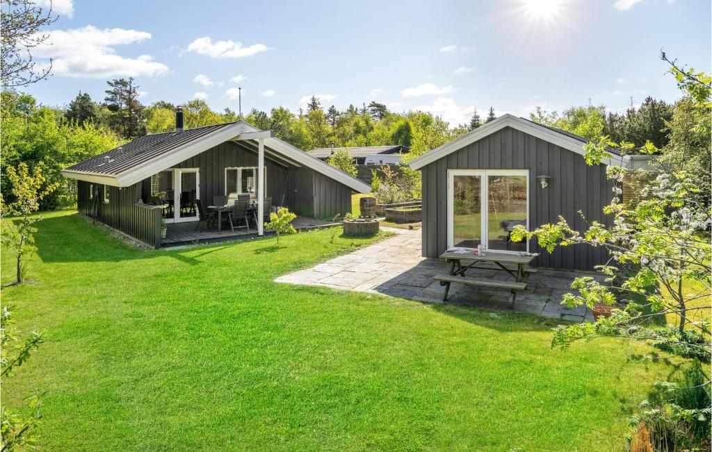 a small shed with a picnic table in a yard at 3 Bedroom Awesome Home In Middelfart in Middelfart