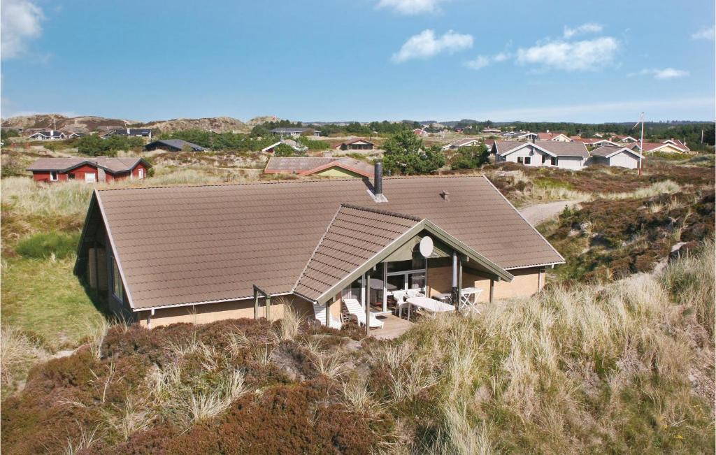 a house with a brown roof on top of a hill at Pet Friendly Home In Henne With Sauna in Henne Strand