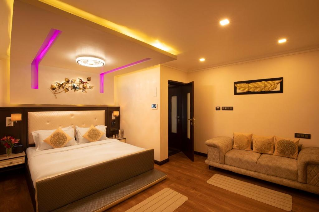 a bedroom with a bed and a couch at Heritage View in Ooty