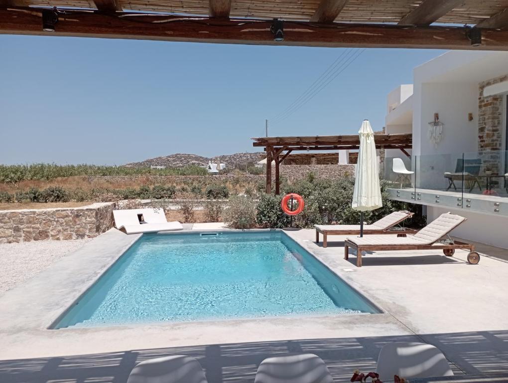 a pool with a view of a house at Bamboo Villa Naxos in Mikri Vigla