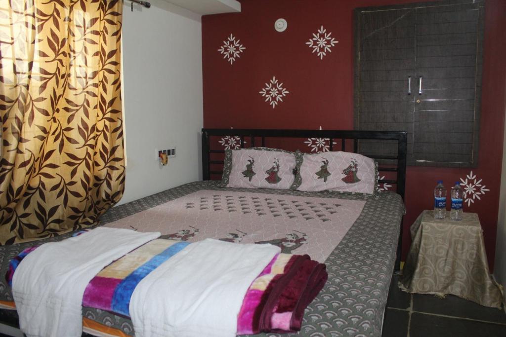 a bedroom with a large bed with snowflakes on the wall at pavan's villa in Hampi