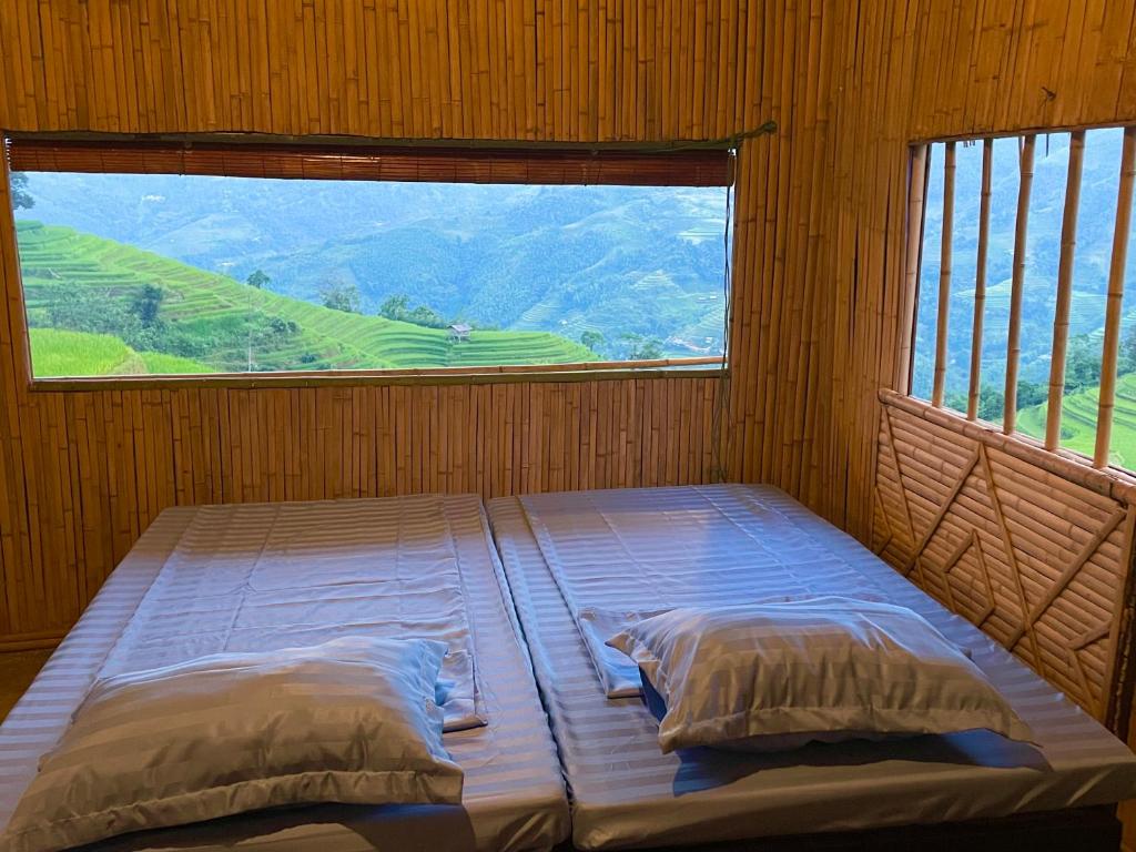 a bed in a room with a large window at Mâm Xôi Homestay 