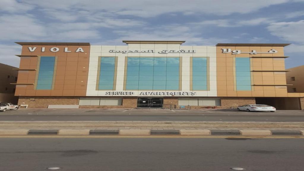 a building with a car parked in front of it at فيولا للشقق المخدومة in Riyadh