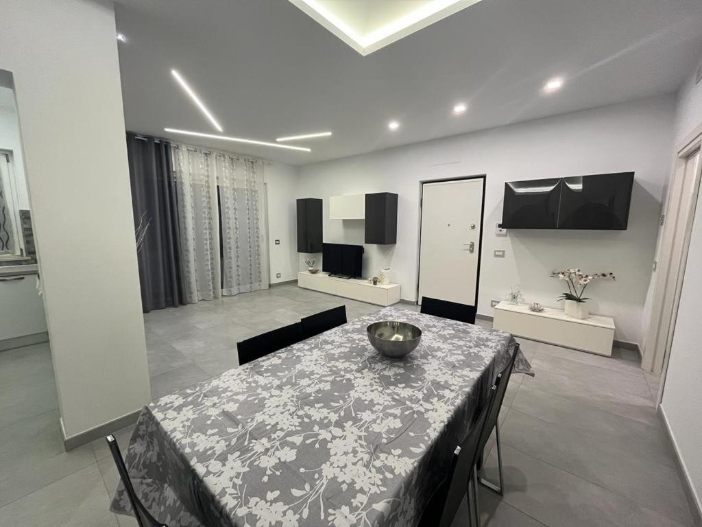 a dining room with a table and a living room at La Casa Di Lilla in Tortoreto Lido