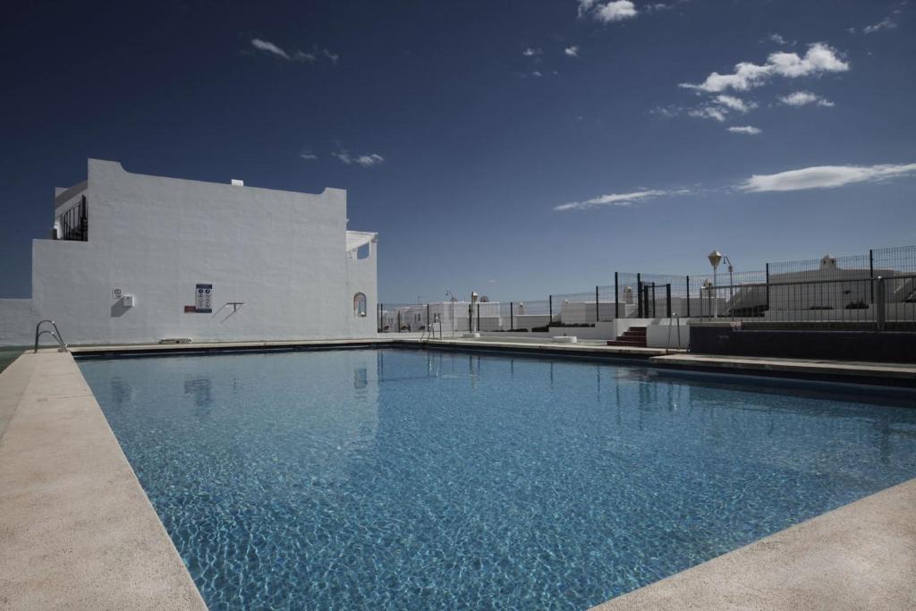 a large swimming pool next to a white building at Vistamojacar in Mojácar